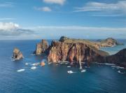 ocky Caribbean coastal landscape with ocean waves and natural cliffs.