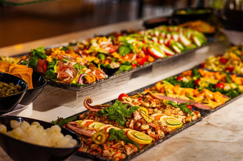 Gourmet buffet featuring a variety of Caribbean dishes at Playa Esmeralda, Miches, Dominican Republic.